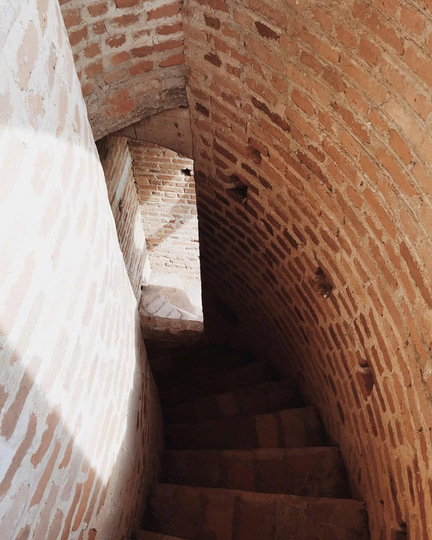Brick spiral staircase curving out of sight
